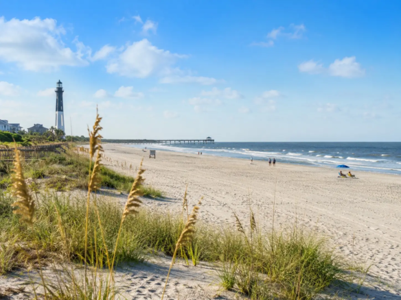 Tybee Island beach with sea oats and dunes — coastal Georgia real estate guide hero image