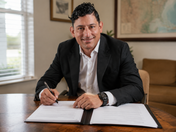 Alex Rodino reviewing closing paperwork at a desk during a Savannah home sale