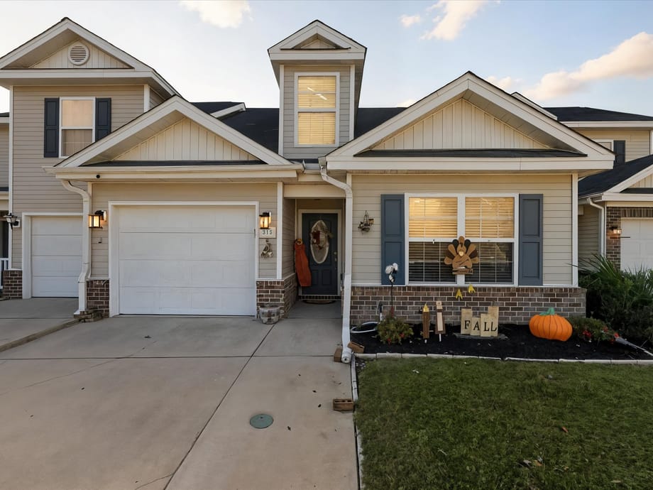 Two-story home for sale in Pooler, GA with a two-car garage and manicured front lawn