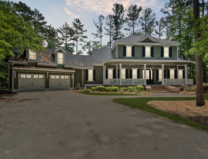 Large Richmond Hill, GA estate home at dusk with a circular drive