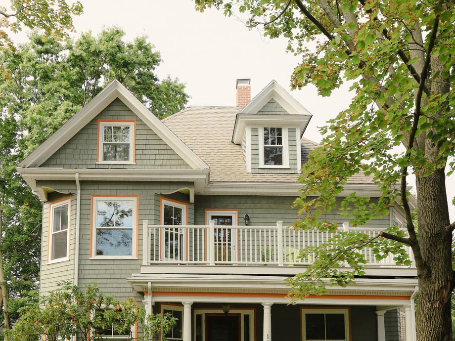 Colorful gingerbread Victorian house with an ornate porch in Savannah's Victorian District, GA